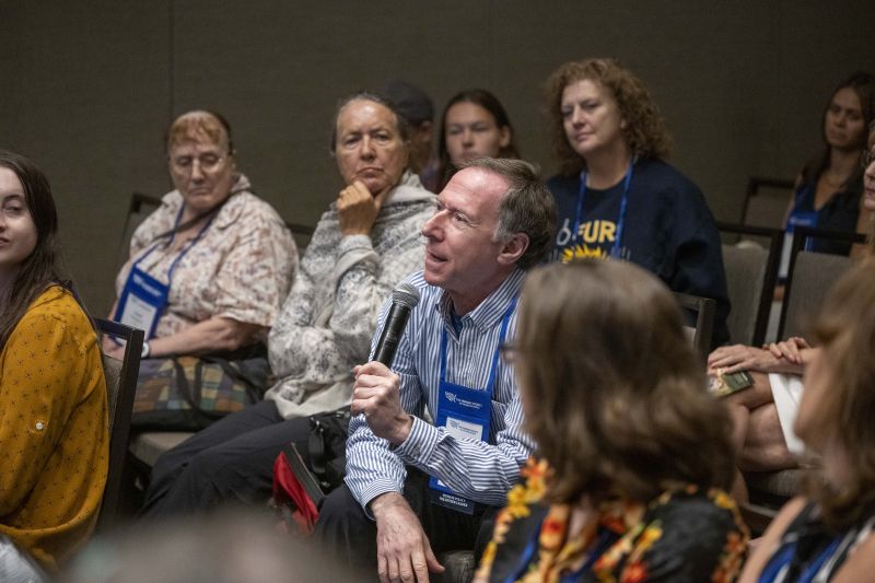 Attendee holding microphone