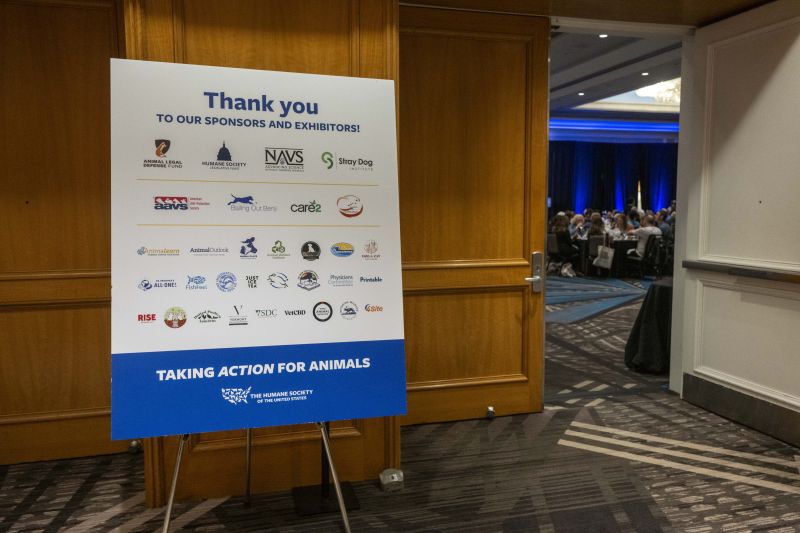 Sign with sponsor logos outside the general session room