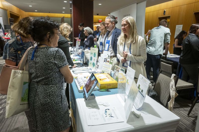 Attendees speaking with exhibitors