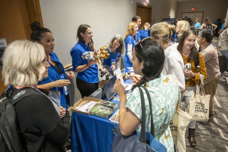 people gathered at a table for handouts