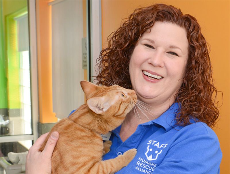 a cat licking a woman's face