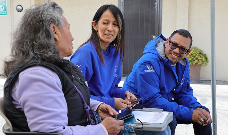 At the North Figueroa Animal Hospital, Maria Soriano chats with Pets for Life Los Angeles staff members Natalie Romero and Robert Sotelo.