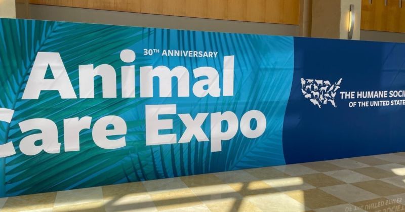 a large sign displaying animal care expo and the hsus logo