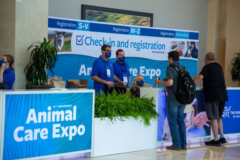 people gathered at the animal care expo registration desk