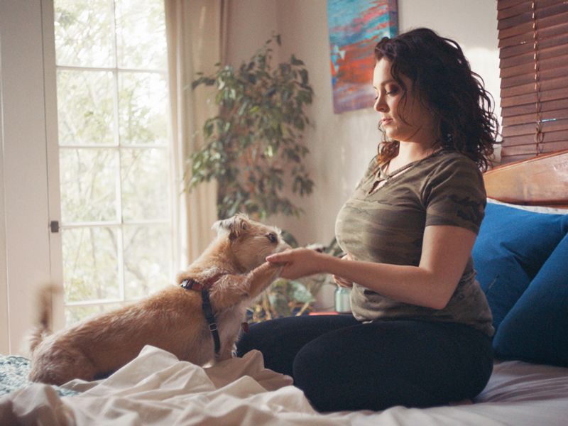 a dog gives a woman his paw