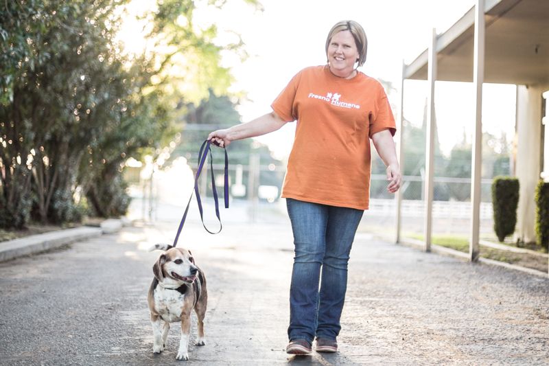 a woman walking a dog