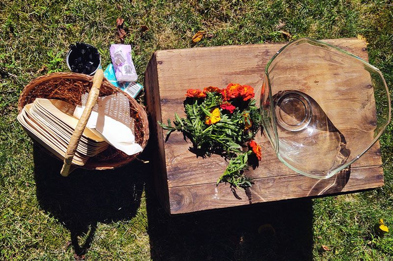 a bowl and flowers alongside a basket