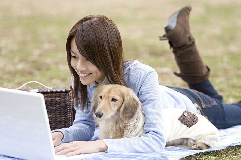 Woman with dog and laptop