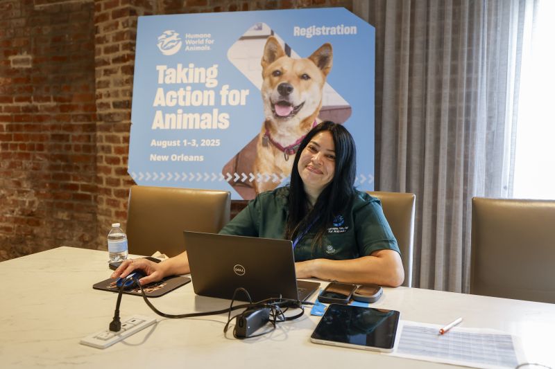A Humane World staff member is ready to check in attendees at TAFA 2025.