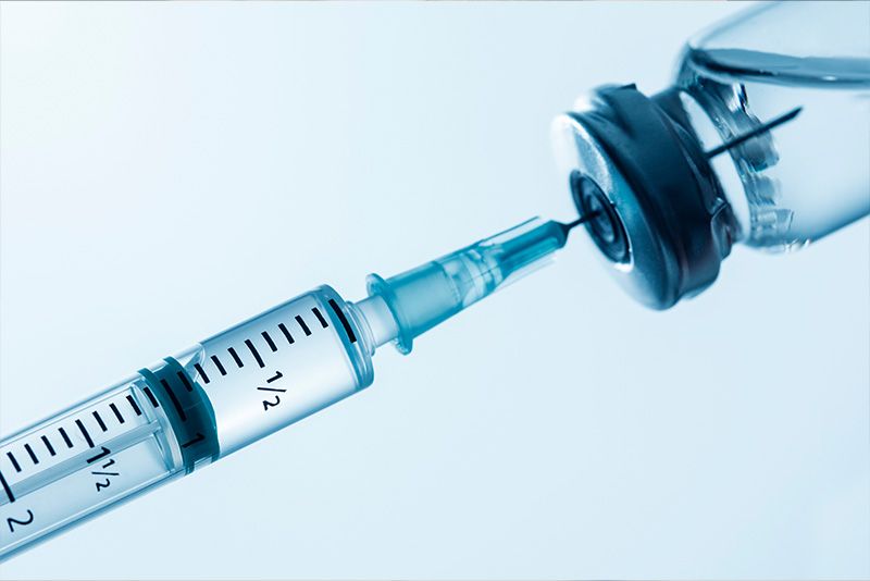 Close up shot of a syringe being filled with an injectable drug.