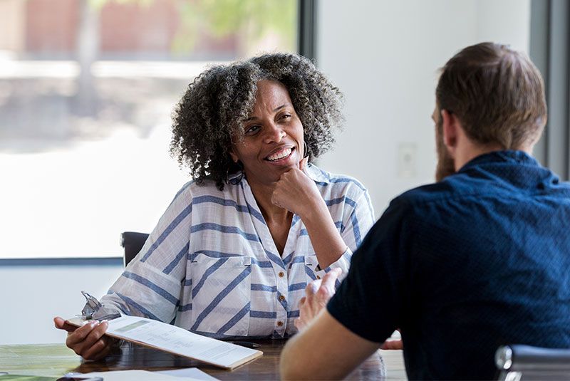 A woman and man meeting for a job interview