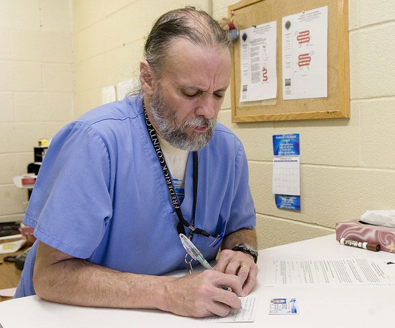 Staff member keeping animal care records