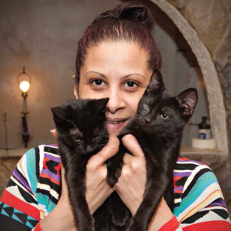 Woman with two black cats