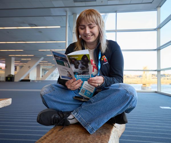 Attendee reading a pocket guide