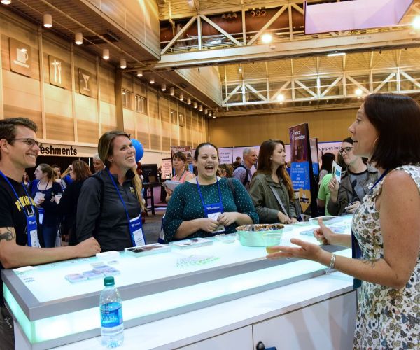 people smiling at an expo booth