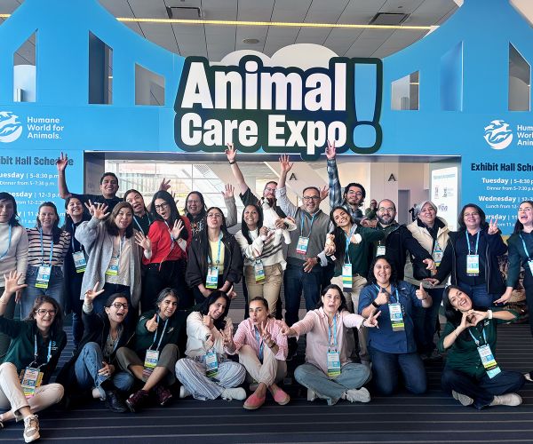 Group of attendees in front of Animal Care Expo sign
