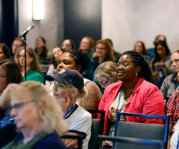 an audience of people viewing a presentation
