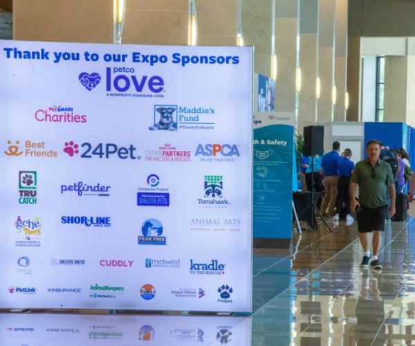 a list of expo sponsors on a large sign at the conference