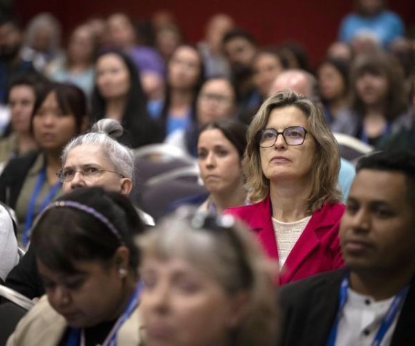 Woman sitting in a workshop crowd