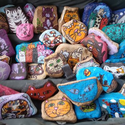 an assortment of colorful rocks painted with images of animals