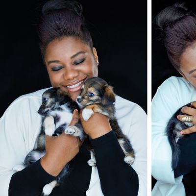 a woman snuggles two small puppies
