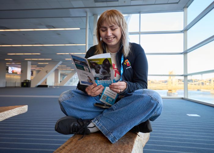 Attendee reading a pocket guide