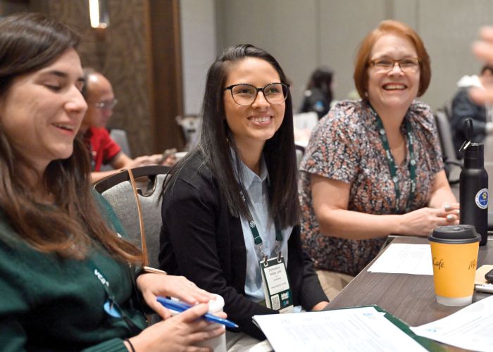 Three attendees enjoy an Expo workshop