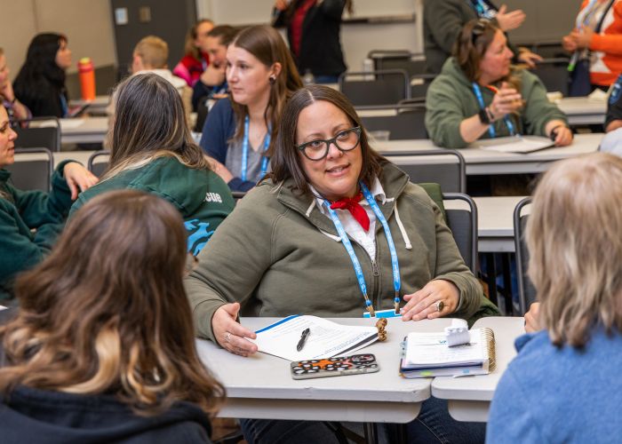 Attendee in a workshop talking to other attendees