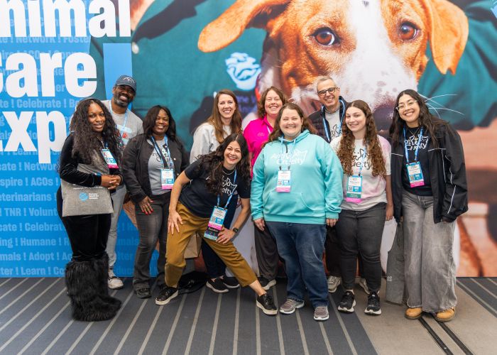 Group of attendees in front of an Expo sign