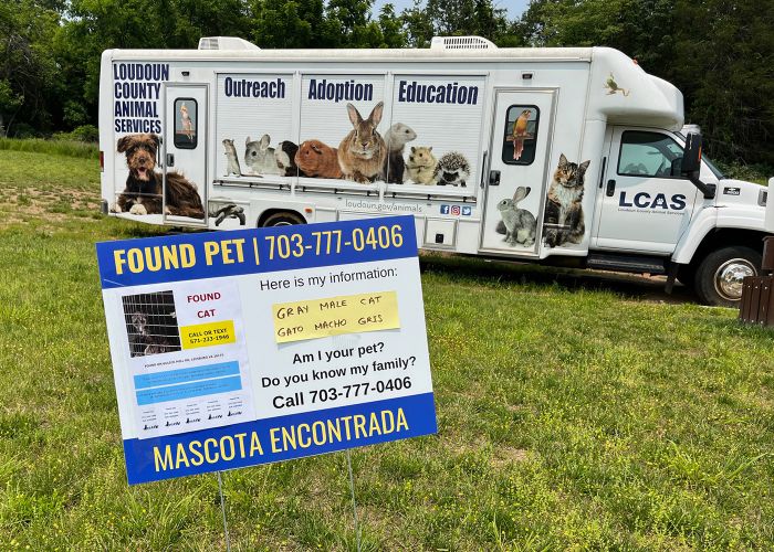 a found pet yard sign in front of an animal shelter transport van