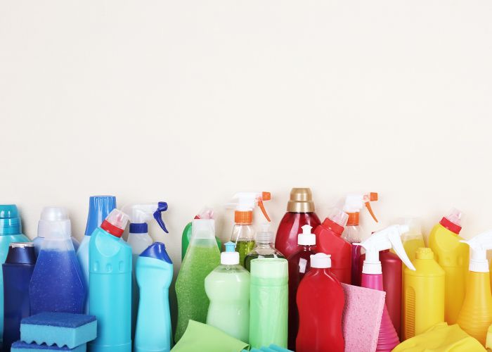 an assortment of cleaning products arranged by color