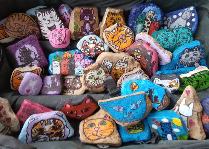 an assortment of colorful rocks painted with images of animals