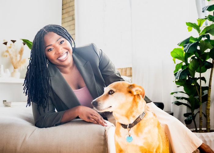 a woman leaning on a couch with a dog