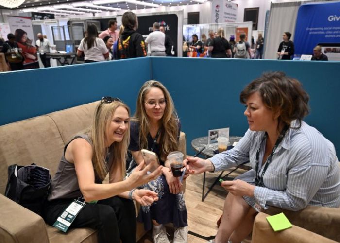 Attendees view conference information on a cellphone.