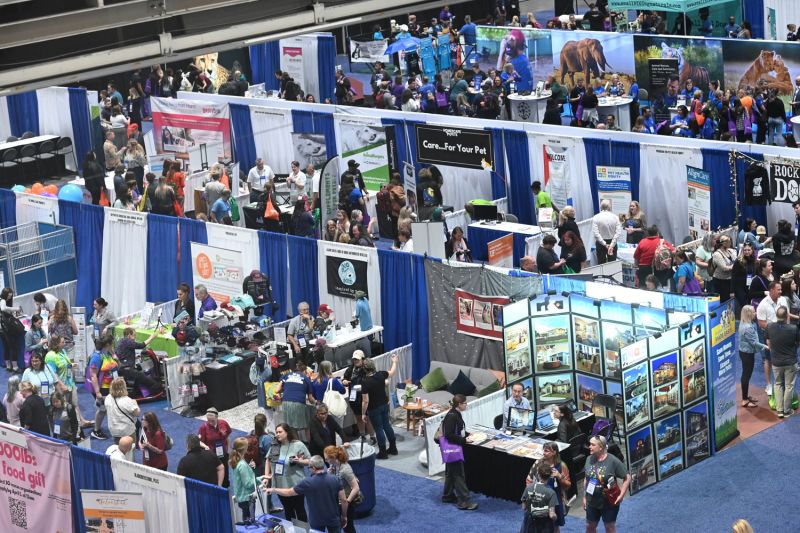 a birds eye view of booths and crowds of participants at the expo exhibit hall