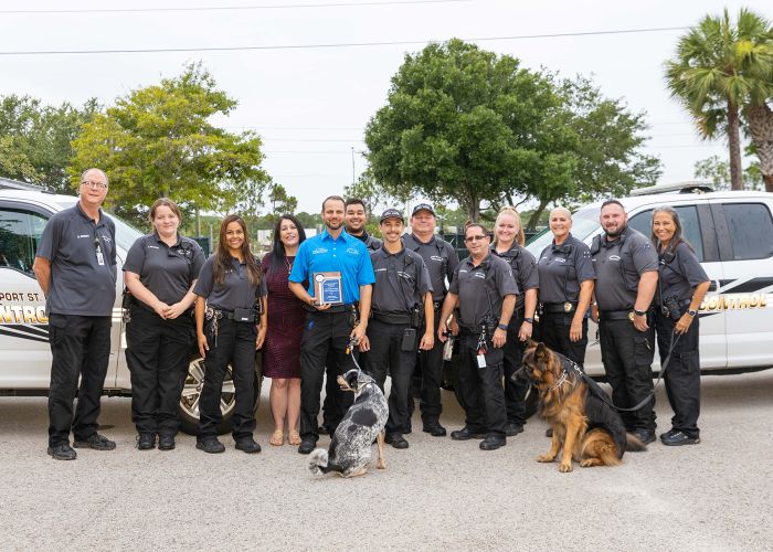 A group of animal control team members with a few dogs.