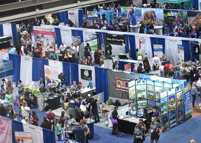 a birds eye view of booths and crowds of participants at the expo exhibit hall